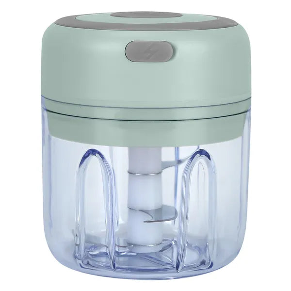 Handheld food chopper with green lid and clear container on a white background