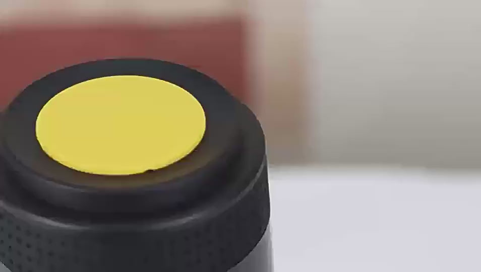 Black portable coffee maker with and a cup of coffee